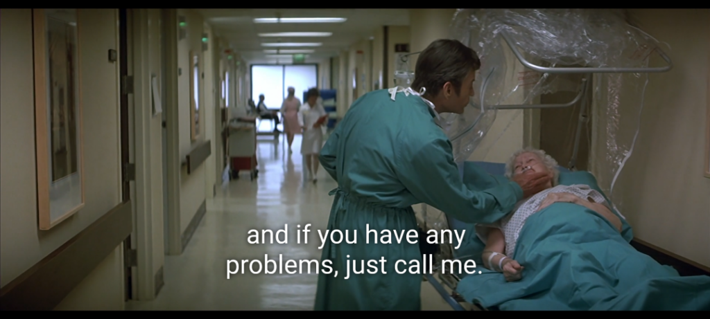 Screenshot from Star Trek IV. McCoy in a teal hospital gown gives an elderly woman a pill and says "and if you have any problems, just call me."