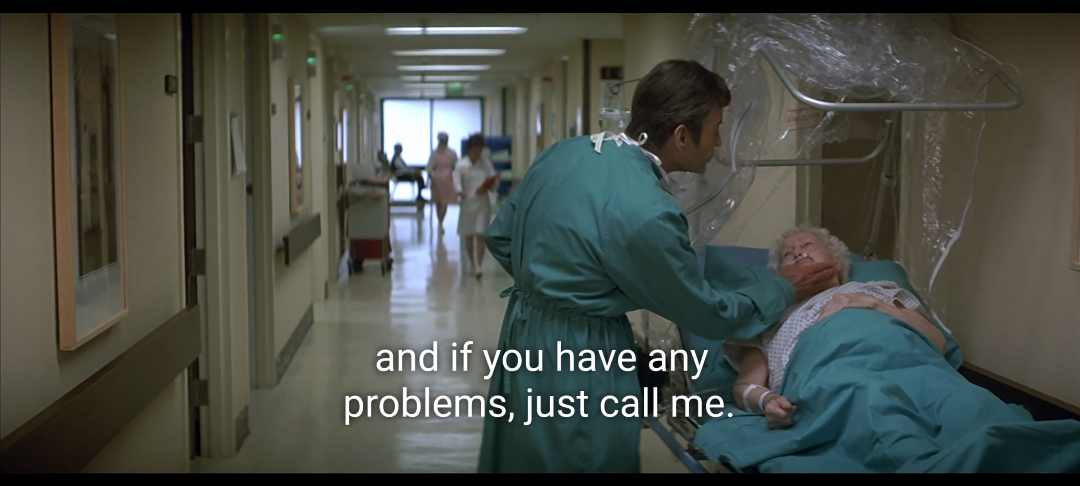 Screenshot from Star Trek IV. McCoy in a teal hospital gown gives an elderly woman a pill and says "and if you have any problems, just call me."